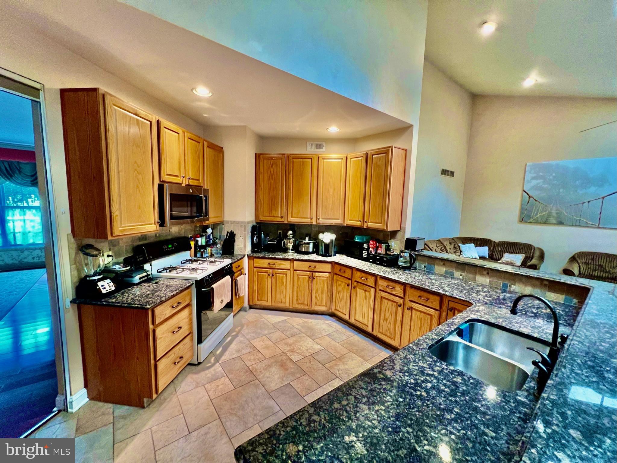 18 Skyline Circle Sewell, NJ 08080 - Photo 21 of 59 a kitchen with stainless steel appliances granite countertop a stove a sink dishwasher and a refrigerator