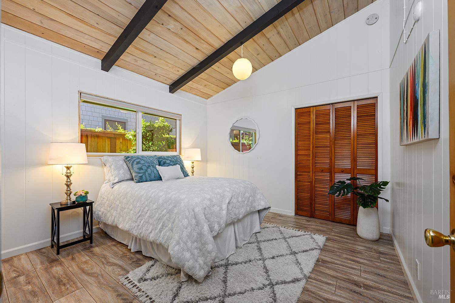 285 Neva Street Sebastopol, CA 95472 - Photo 19 of 39 a bedroom with a bed and wooden floor