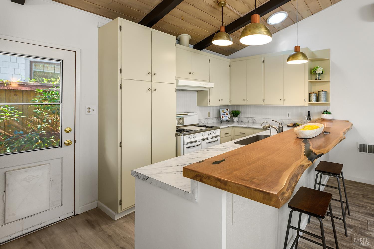 285 Neva Street Sebastopol, CA 95472 - Photo 8 of 39 a room with stainless steel appliances granite countertop a refrigerator a sink a stove and white cabinets with wooden floor