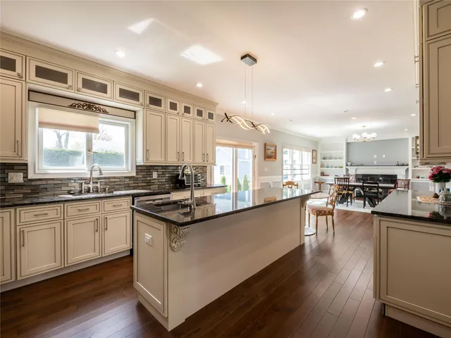 a large kitchen with granite countertop lots of counter top space and stainless steel appliances
