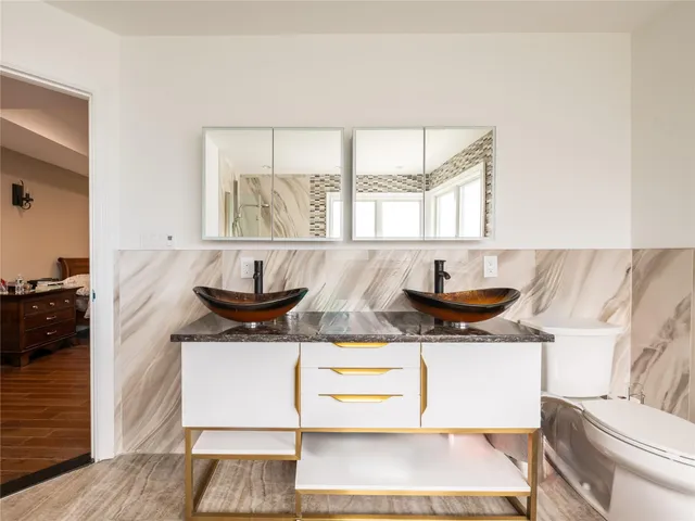 a kitchen with stainless steel appliances a sink a stove and a wooden floor