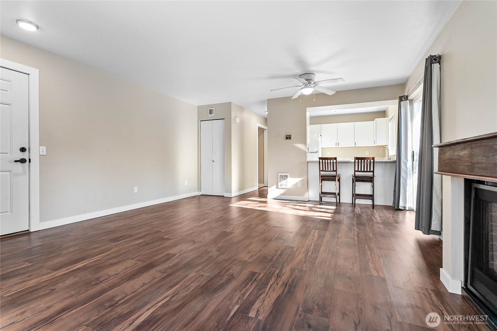 3350 Northwest Avenue, Unit 102 Bellingham, WA 98225 - Photo 11 of 28 an empty room with wooden floor fireplace and window