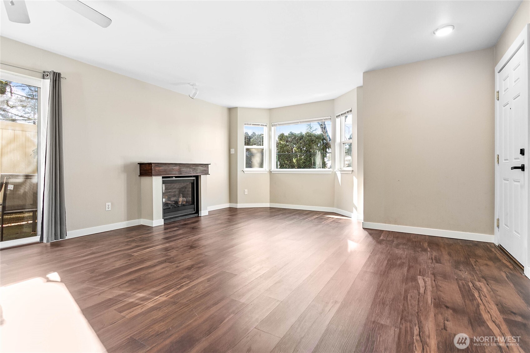 3350 Northwest Avenue, Unit 102 Bellingham, WA 98225 - Photo 12 of 28 an empty room with wooden floor and windows