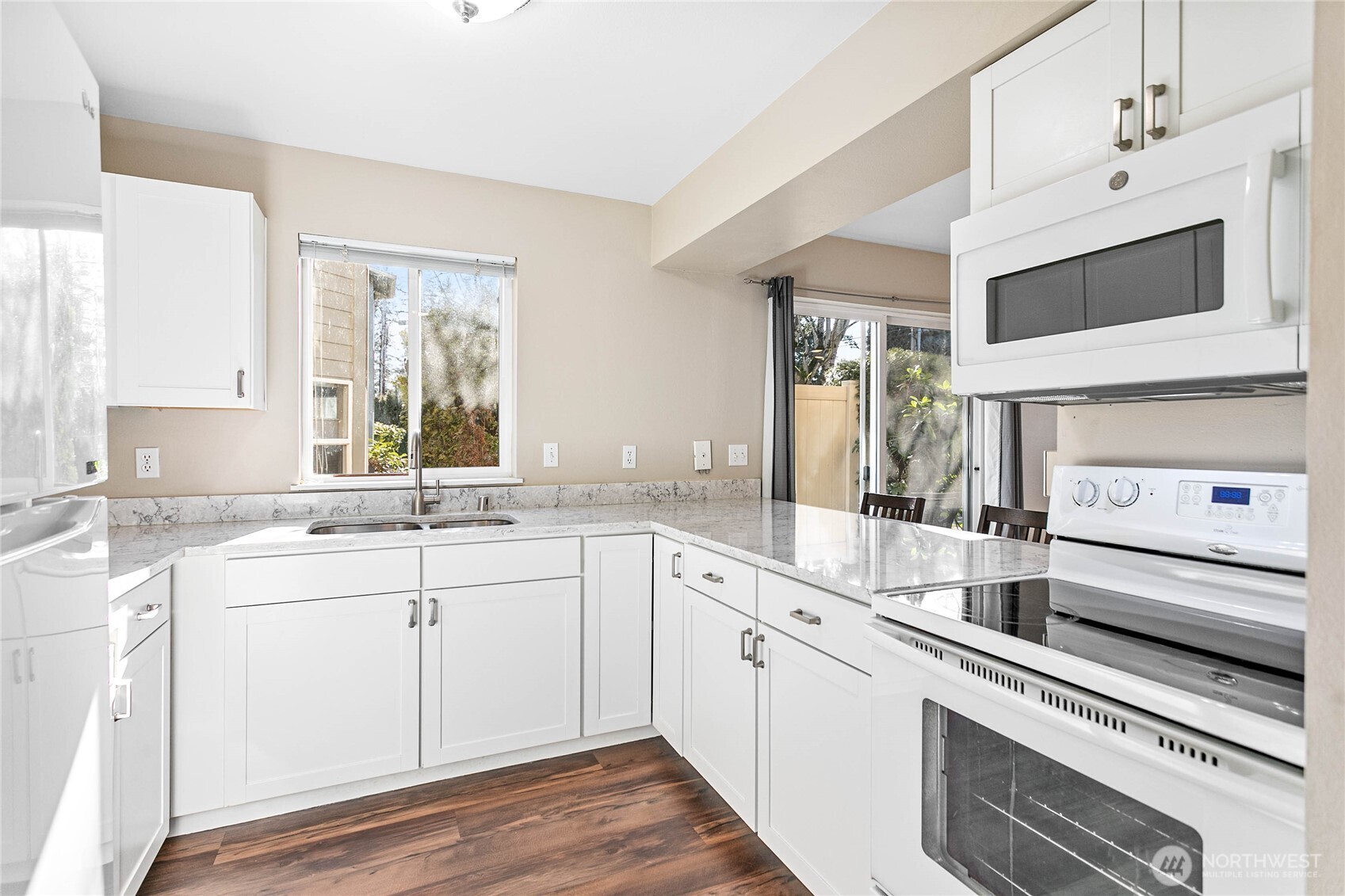 3350 Northwest Avenue, Unit 102 Bellingham, WA 98225 - Photo 17 of 28 a kitchen with a sink stove and cabinets