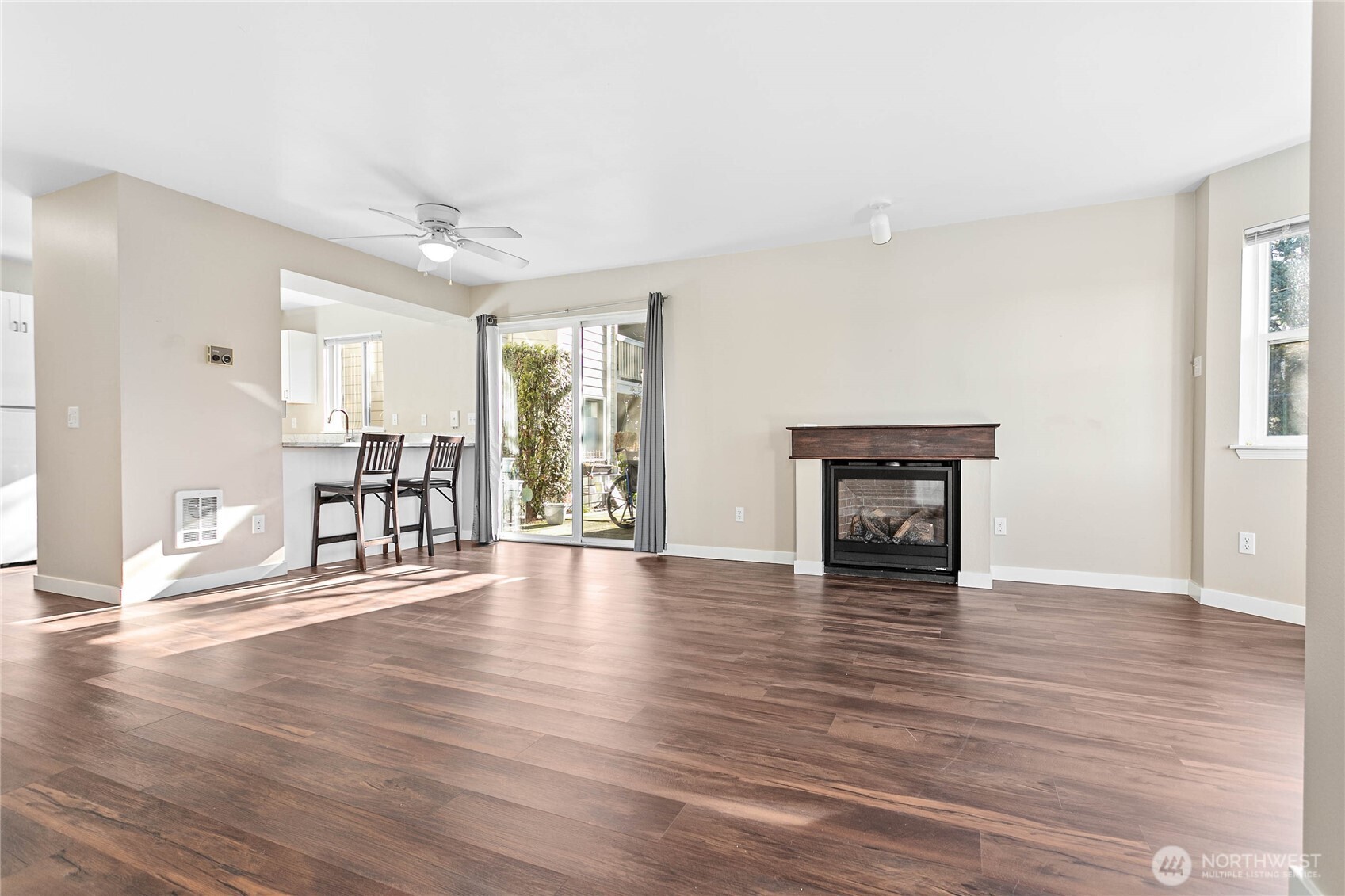 3350 Northwest Avenue, Unit 102 Bellingham, WA 98225 - Photo 9 of 28 a view of an empty room with wooden floor and a window