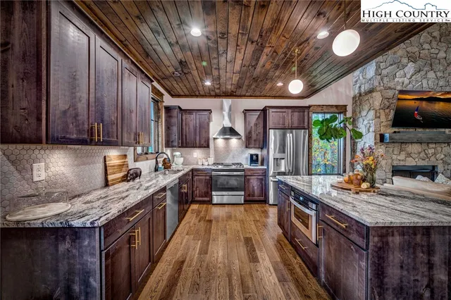 a kitchen with wooden cabinets and stainless steel appliances