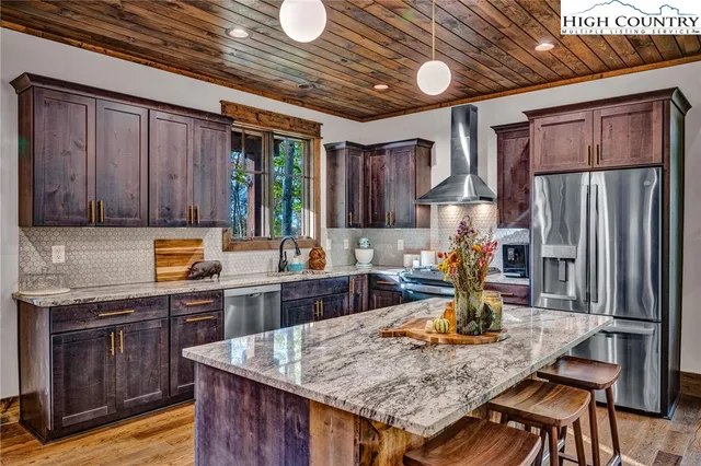 a kitchen with cabinets appliances and a counter space