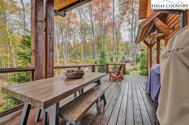 a view of balcony with wooden floor and outdoor seating