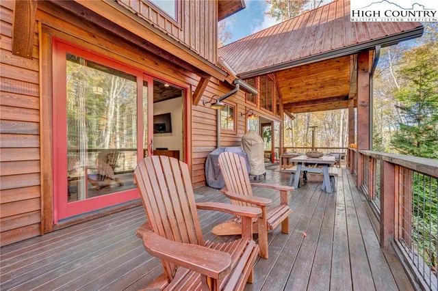 a view of a patio with table and chairs and wooden floor