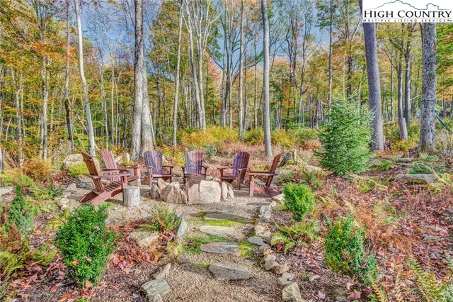 a view of swimming pool with outdoor seating and plants