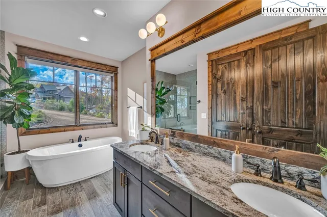 a bathroom with a double vanity sink and a large mirror