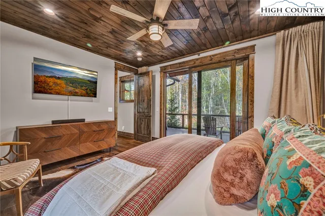 a bedroom with furniture and large windows