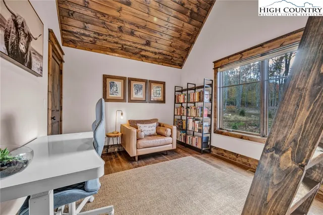 a living room with furniture and a floor to ceiling window