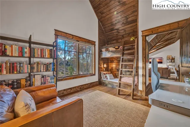 a living room with furniture and a book shelf