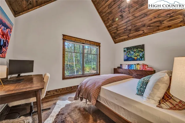 a bedroom with a bed and a desk