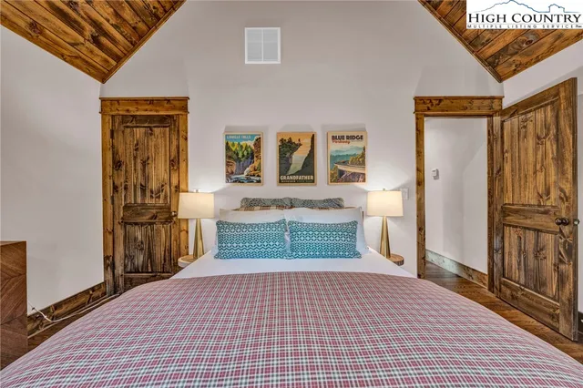 a room with a bed and a refrigerator