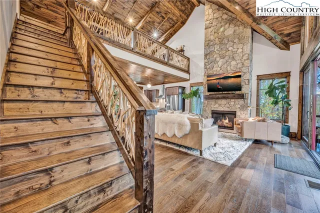 a living room with furniture a fireplace and a flat screen tv