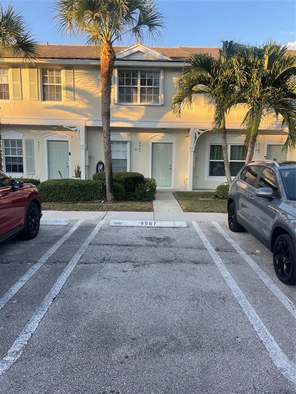 9967 Northwest 56th Place, Unit 9967 Coral Springs, FL 33076 - Photo 2 of 38 a view of a car parked in front of a house