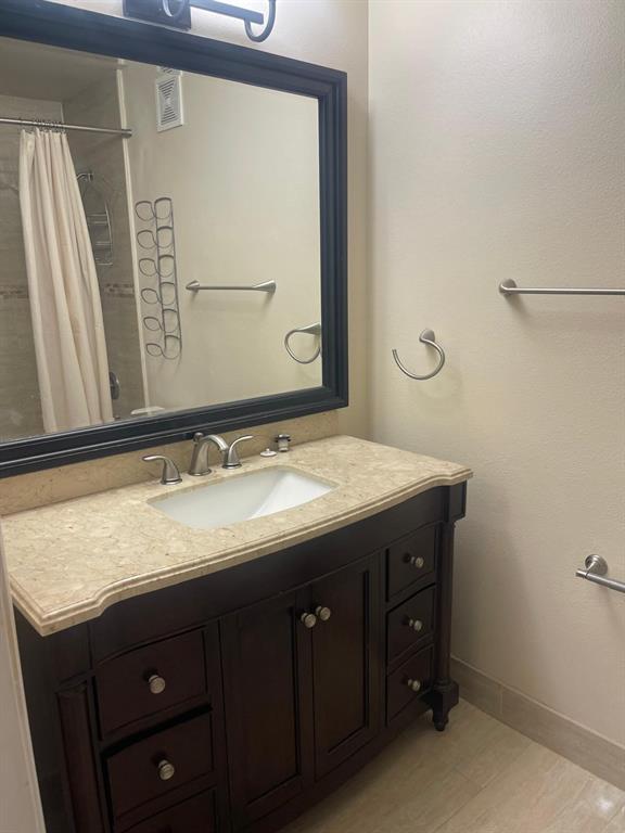 9967 Northwest 56th Place, Unit 9967 Coral Springs, FL 33076 - Photo 30 of 38 a bathroom with a granite countertop sink vanity and mirror