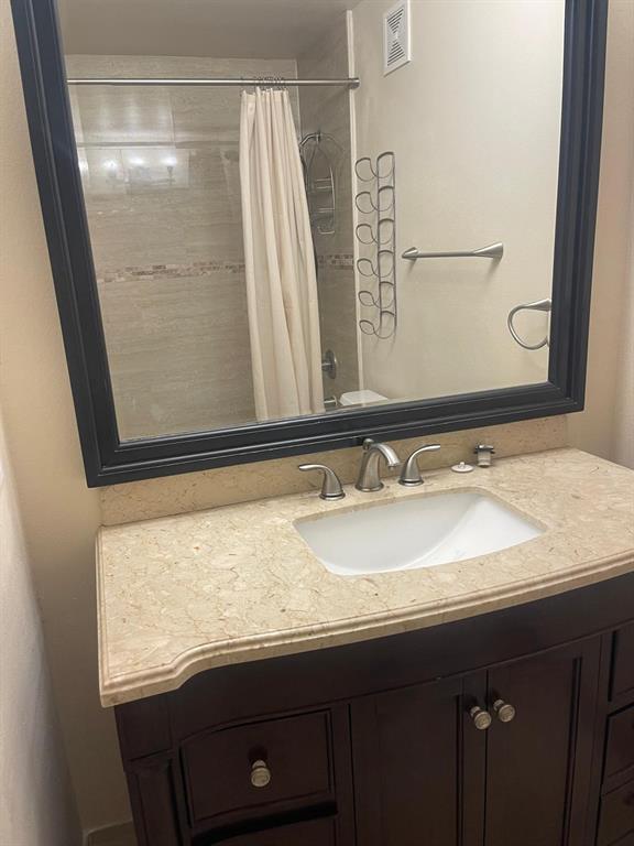 9967 Northwest 56th Place, Unit 9967 Coral Springs, FL 33076 - Photo 31 of 38 a bathroom with a sink and a mirror