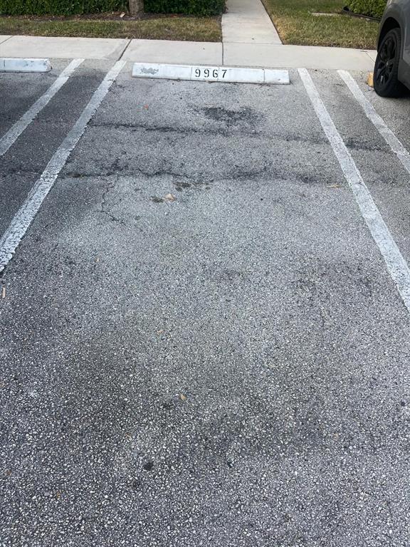 9967 Northwest 56th Place, Unit 9967 Coral Springs, FL 33076 - Photo 38 of 38 a view of a street with a car parked on the road