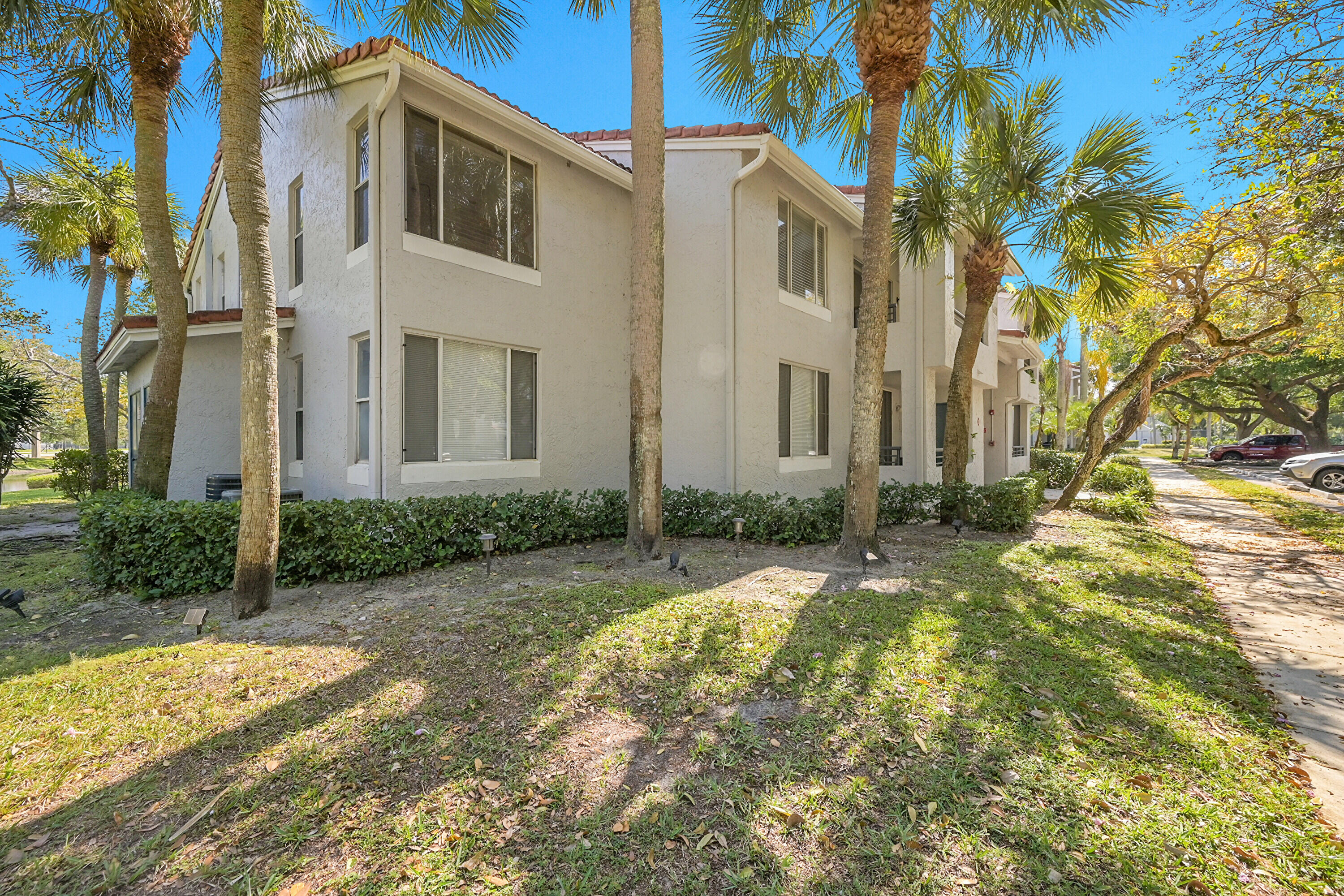 931 Lyons Road, Unit 4201 Coconut Creek, FL 33063 - Photo 21 of 47 a view of a white house with a large tree