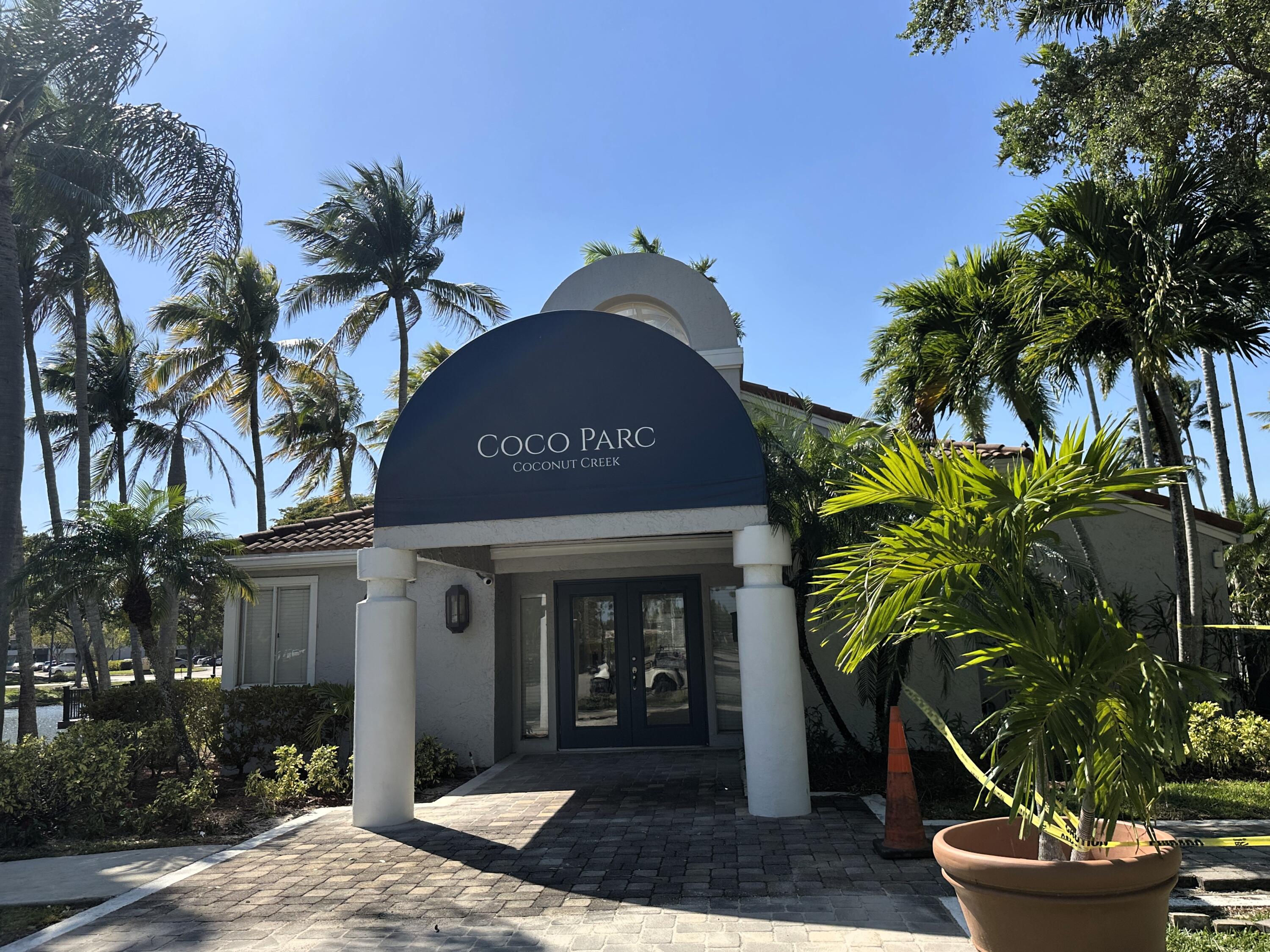 931 Lyons Road, Unit 4201 Coconut Creek, FL 33063 - Photo 23 of 47 a front view of a house with garden