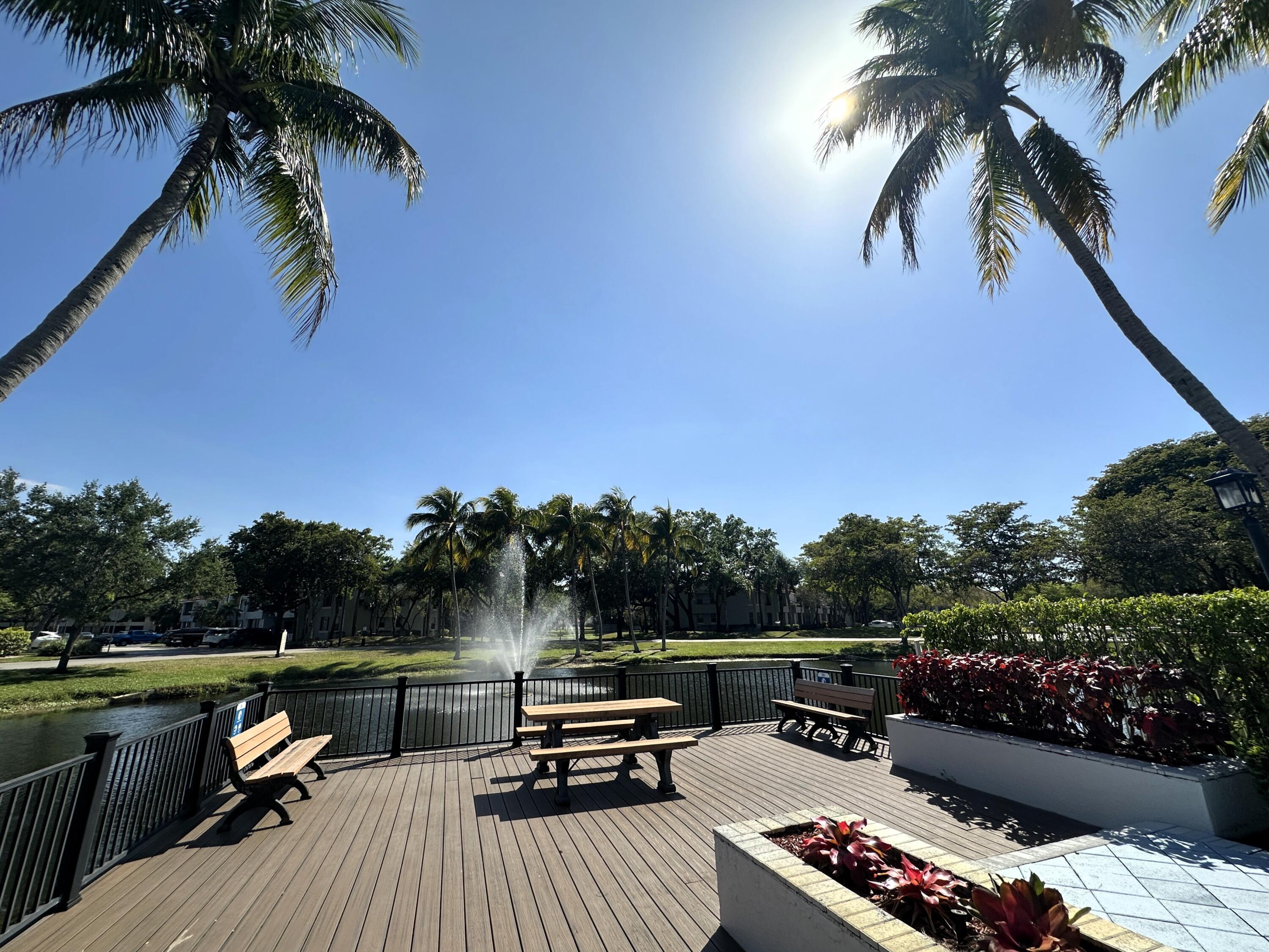 931 Lyons Road, Unit 4201 Coconut Creek, FL 33063 - Photo 24 of 47 a view of a roof deck with couches and a potted plant