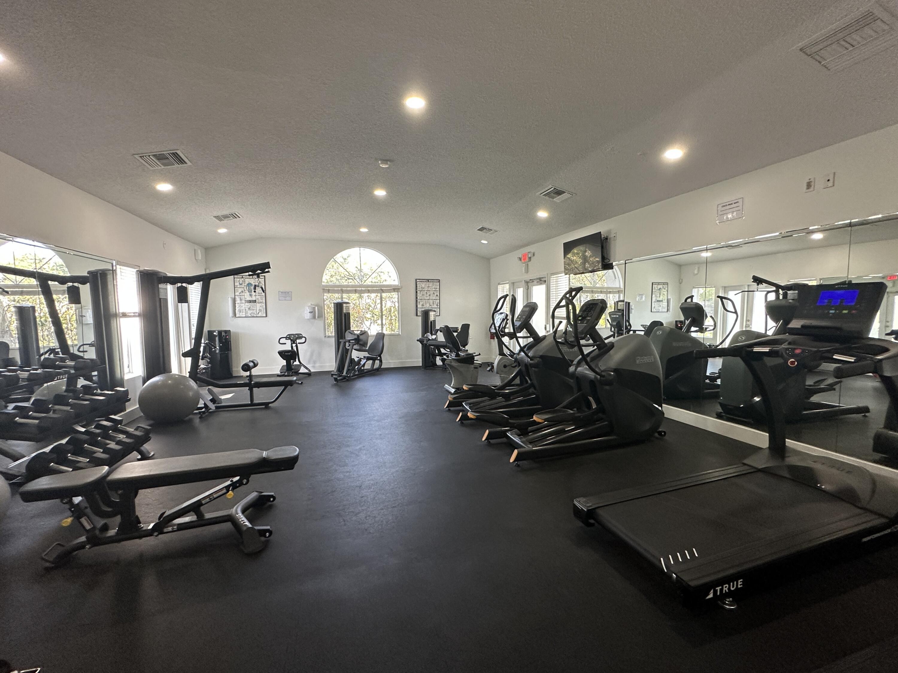 931 Lyons Road, Unit 4201 Coconut Creek, FL 33063 - Photo 26 of 47 a room with gym equipment and a view of living room