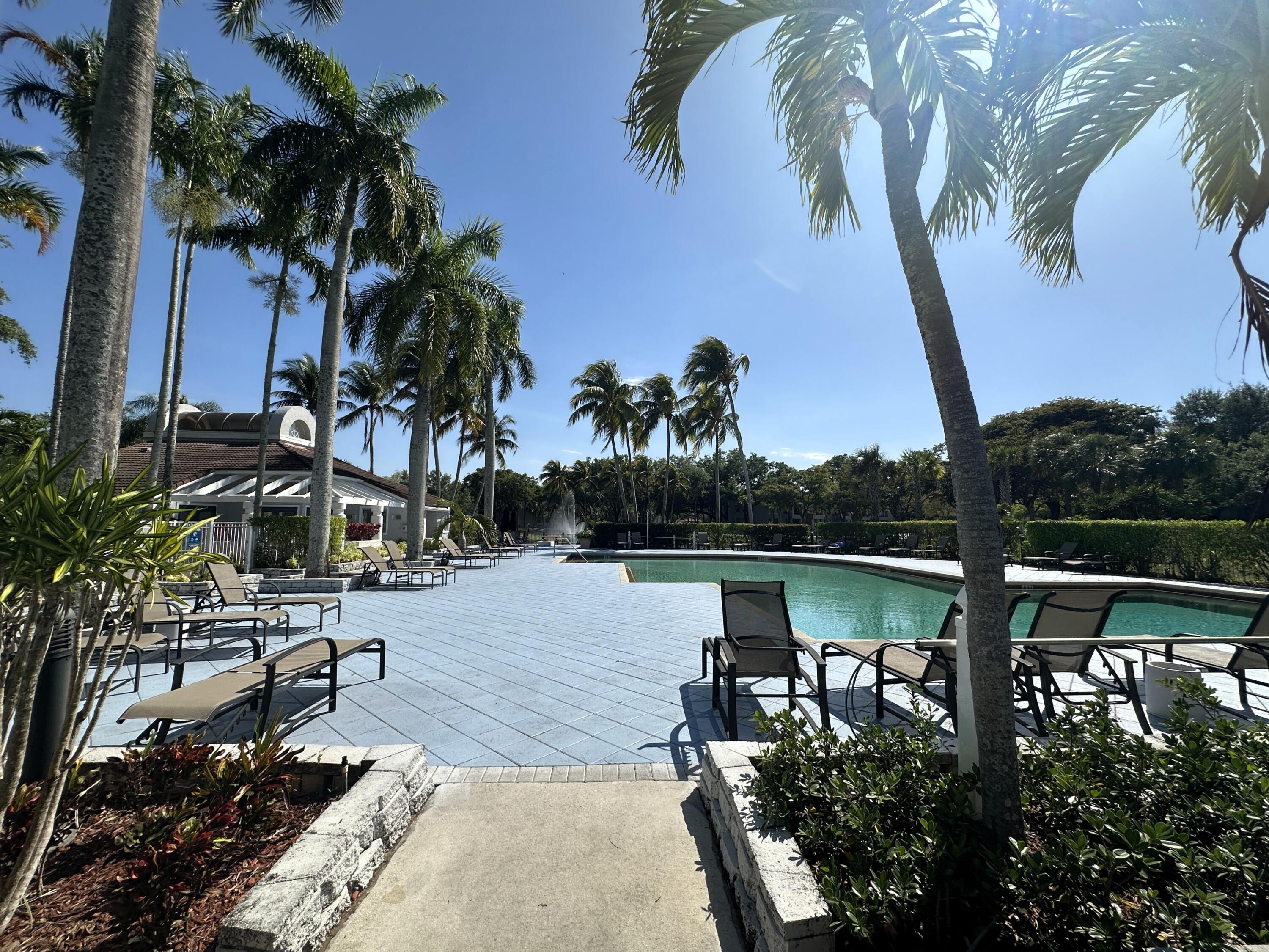 931 Lyons Road, Unit 4201 Coconut Creek, FL 33063 - Photo 28 of 47 a view of a lake with a palm tree