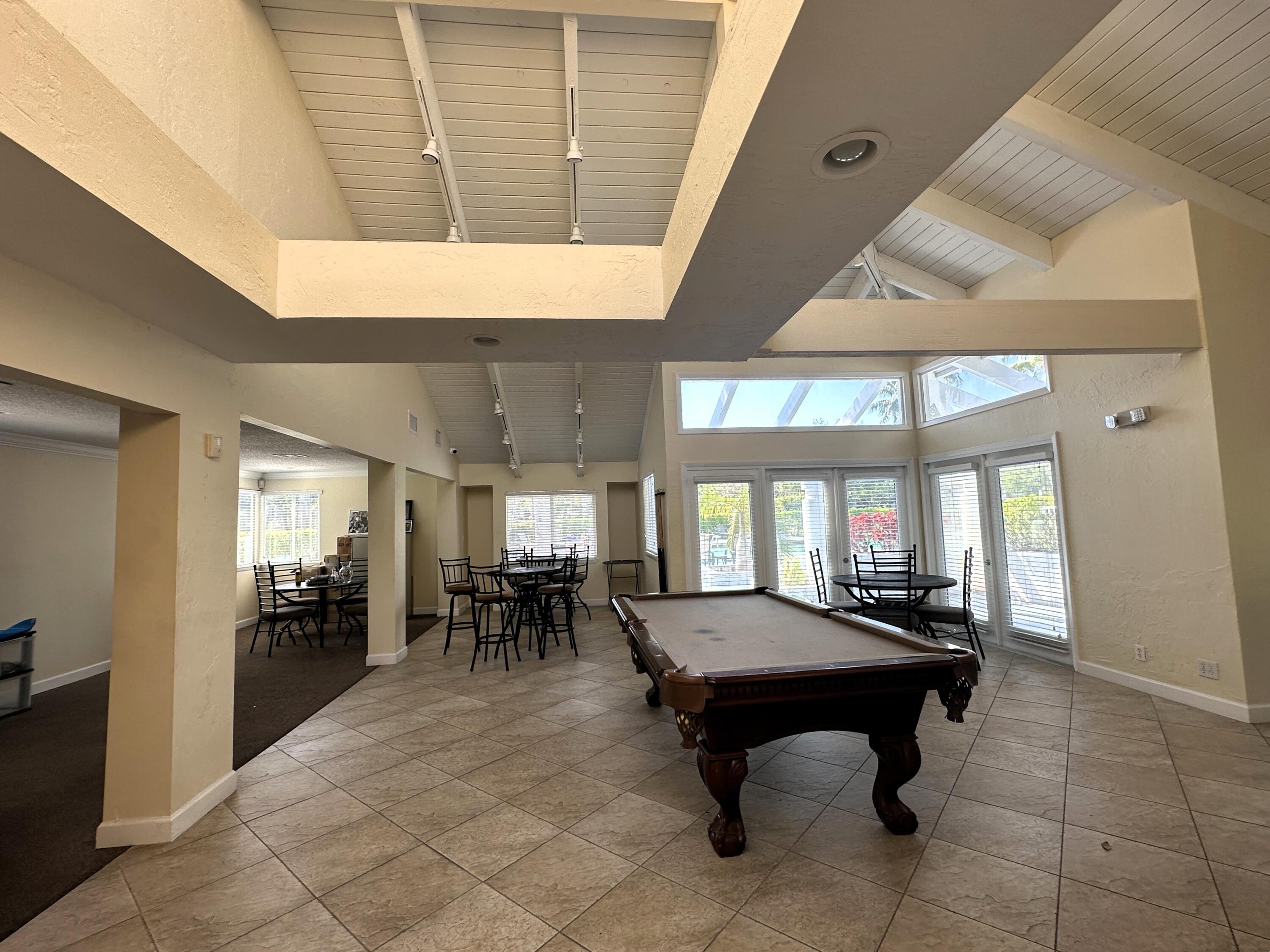 931 Lyons Road, Unit 4201 Coconut Creek, FL 33063 - Photo 30 of 47 a living room with furniture a table and kitchen view