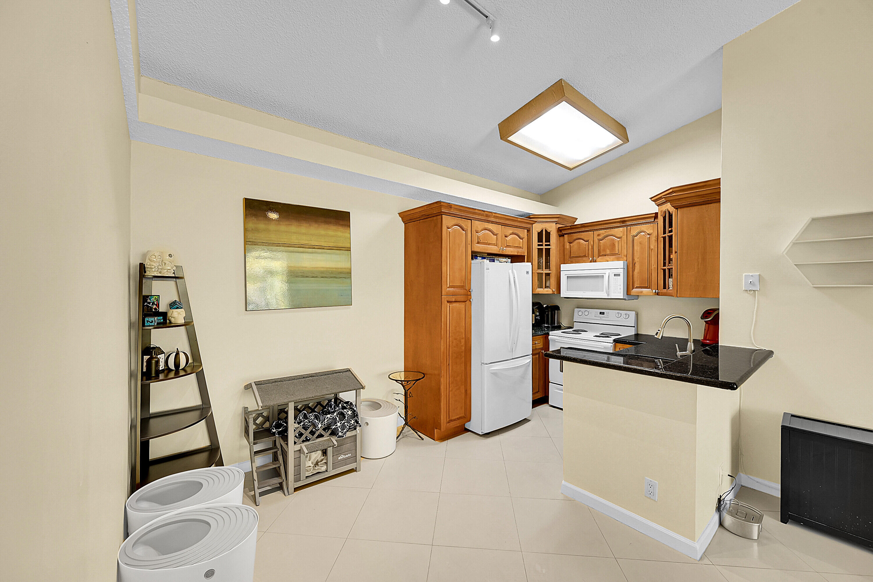 931 Lyons Road, Unit 4201 Coconut Creek, FL 33063 - Photo 4 of 47 a kitchen with stainless steel appliances a refrigerator and a stove top oven