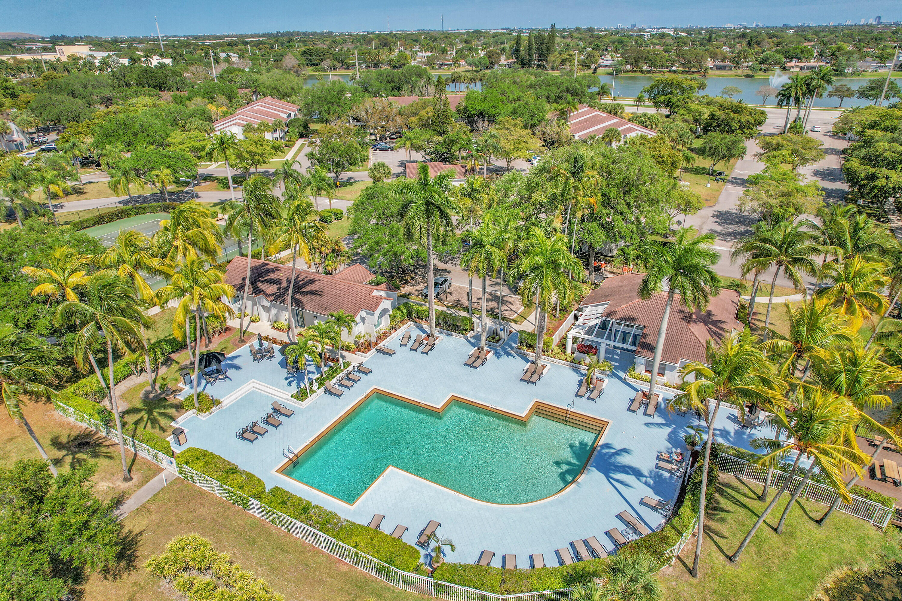 931 Lyons Road, Unit 4201 Coconut Creek, FL 33063 - Photo 41 of 47 an aerial view of a house with a yard and lake view