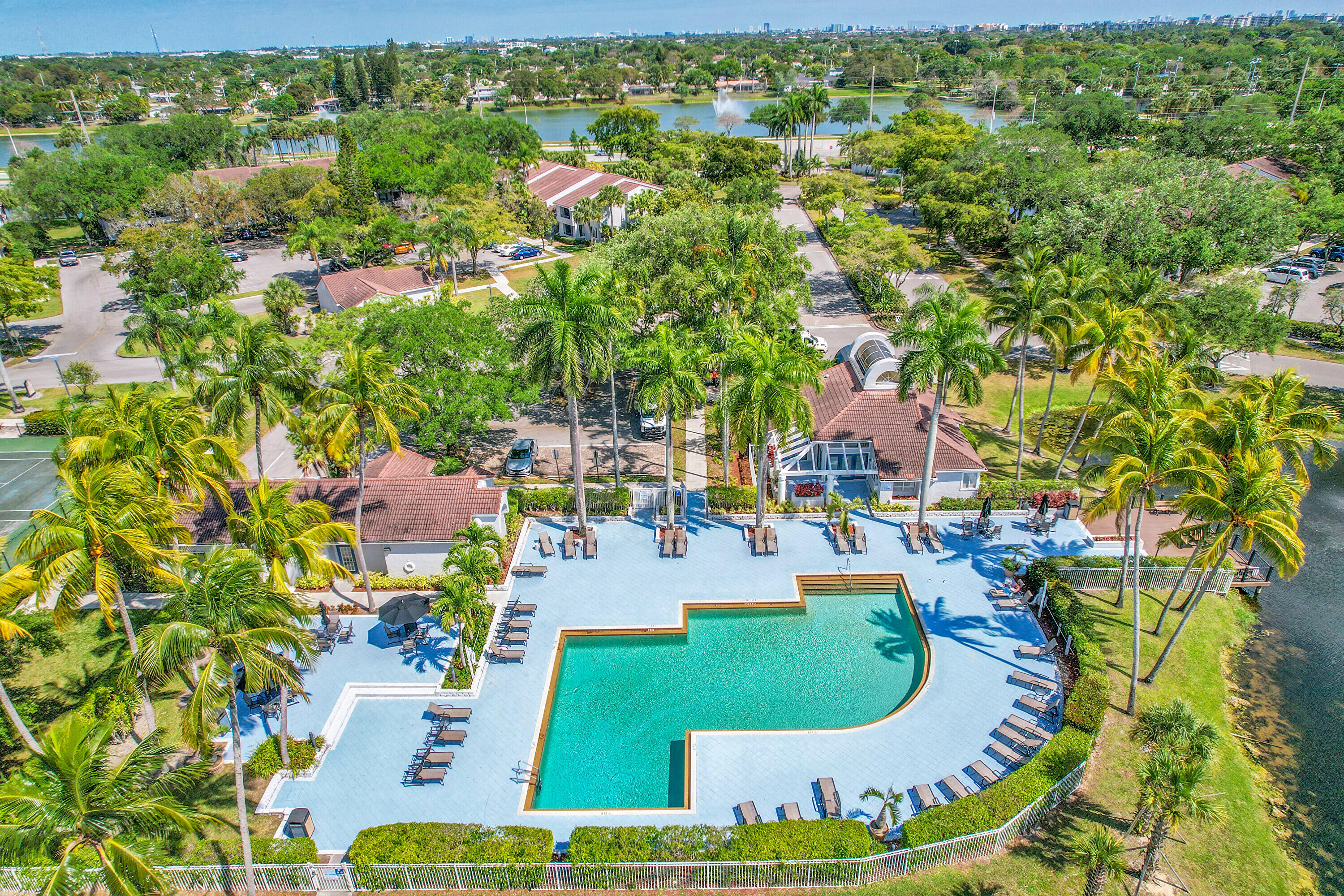 931 Lyons Road, Unit 4201 Coconut Creek, FL 33063 - Photo 42 of 47 an aerial view of a house with a garden and lake view