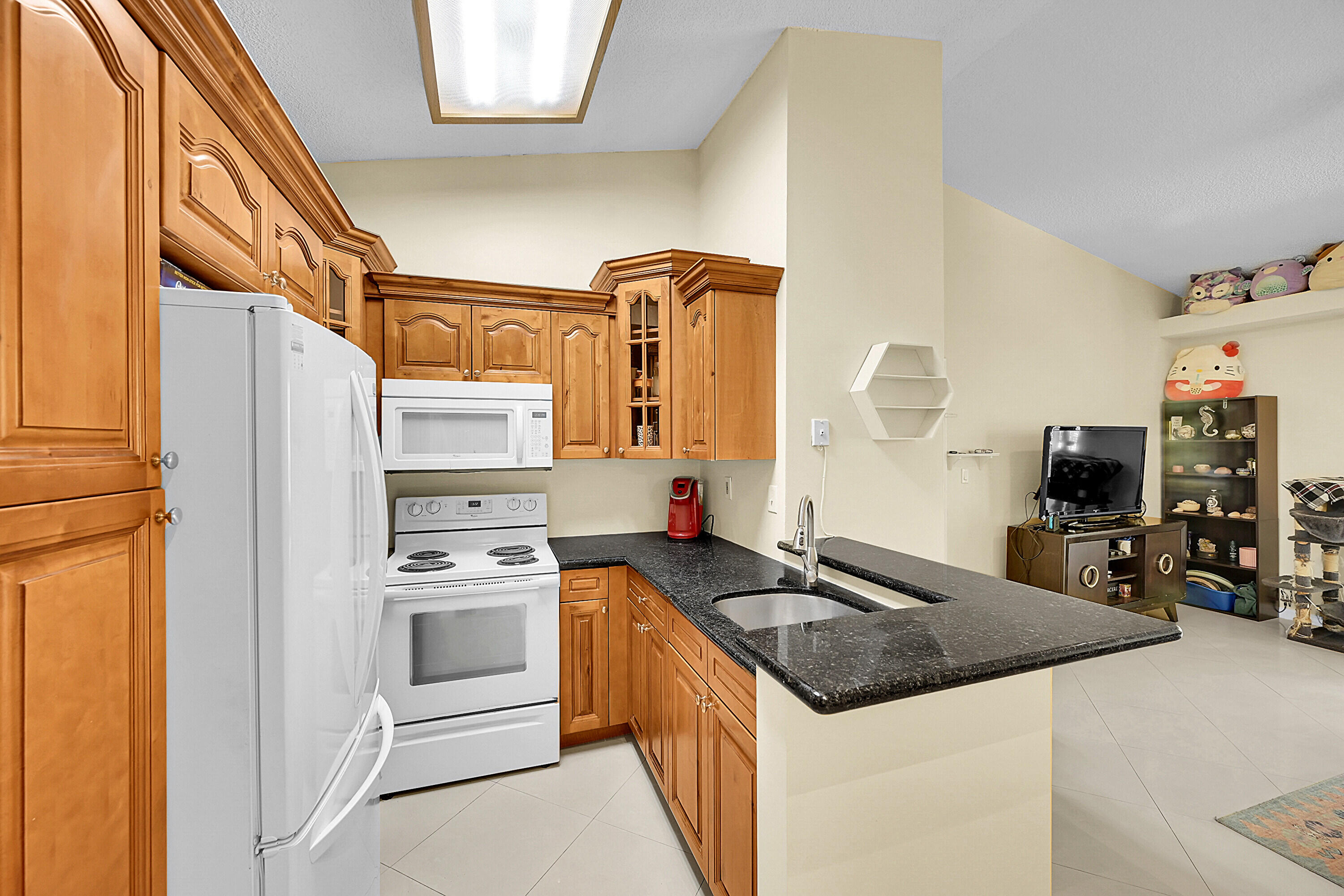 931 Lyons Road, Unit 4201 Coconut Creek, FL 33063 - Photo 5 of 47 a kitchen with stainless steel appliances granite countertop a sink stove and refrigerator