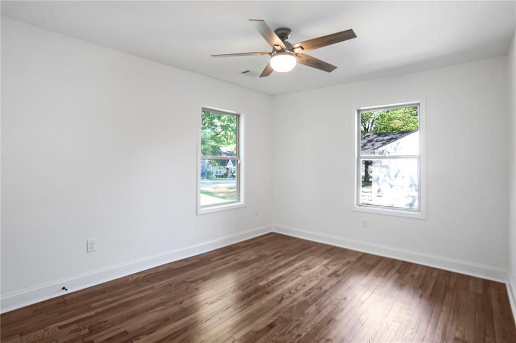 1321 Avon Avenue Southwest Atlanta, GA 30310 - Photo 12 of 20 a view of an empty room with wooden floor and a window