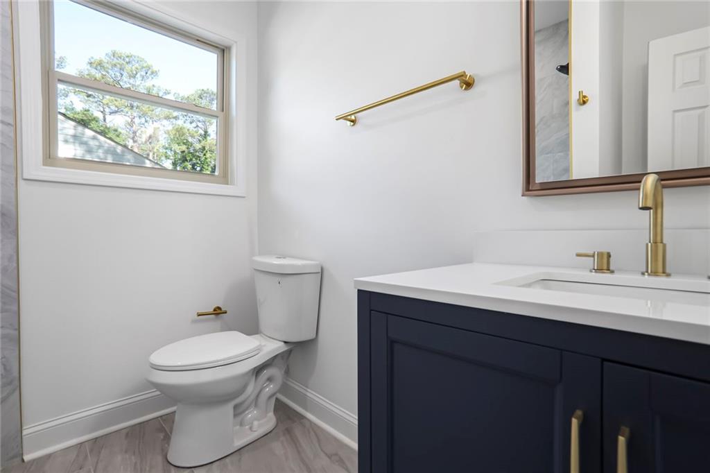 1321 Avon Avenue Southwest Atlanta, GA 30310 - Photo 13 of 20 a bathroom with a toilet a sink and a window