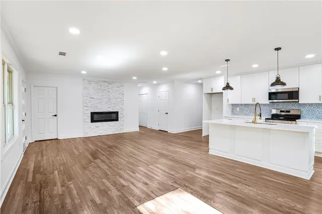 a view of kitchen with sink and wooden floor