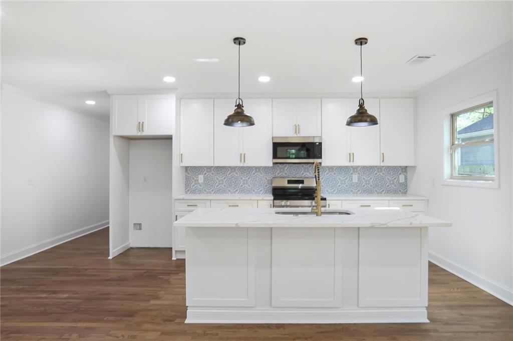 1321 Avon Avenue Southwest Atlanta, GA 30310 - Photo 5 of 20 a kitchen with kitchen island a counter top space a sink and cabinets