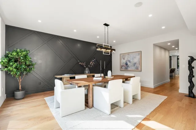 a room with stainless steel appliances kitchen island a chandelier and view of kitchen