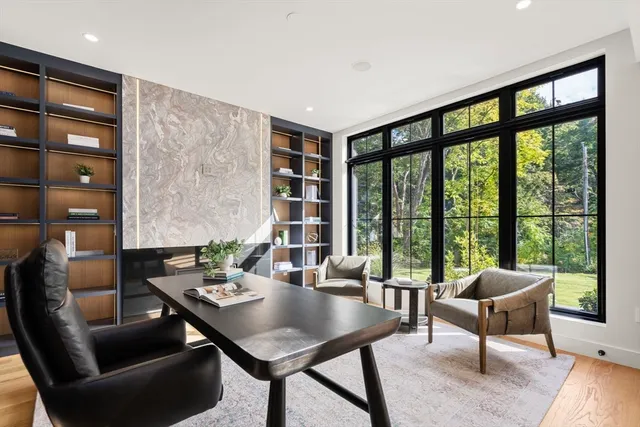 a living room with furniture and a floor to ceiling window