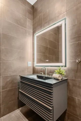 a bedroom with a large bed and a flat tv screen