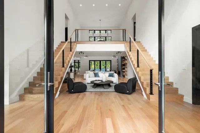 a view of hall way with furniture and floor to ceiling window