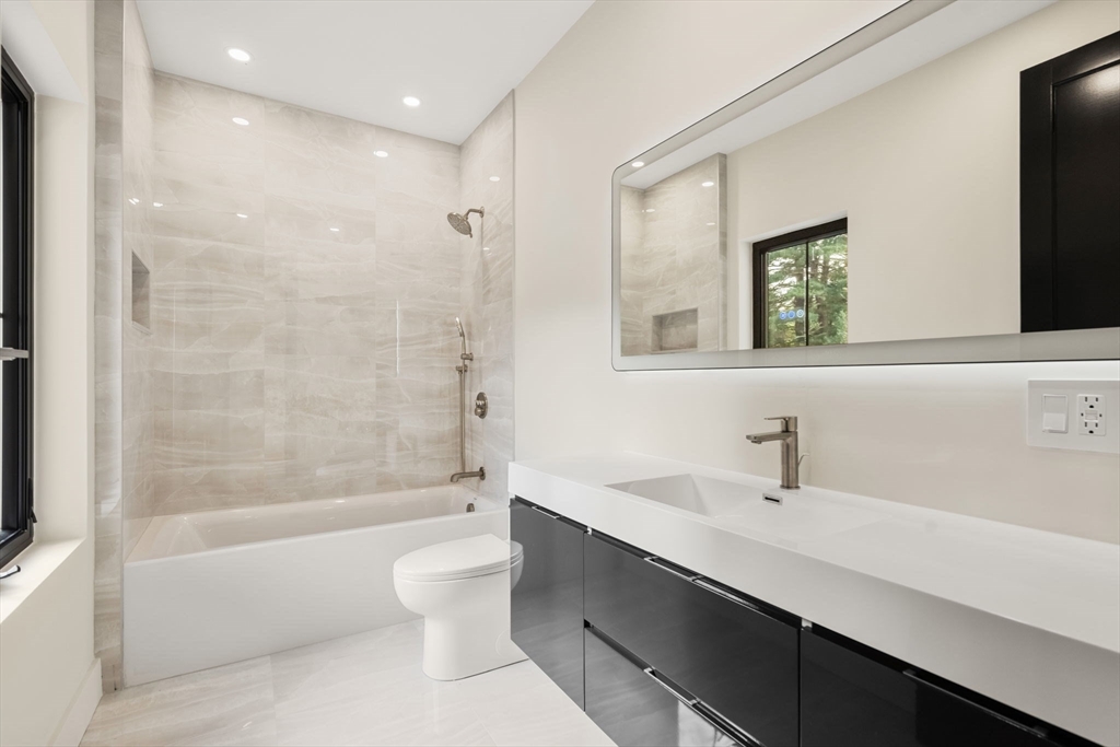 68 Locust Lane Needham, MA 02492 - Photo 26 of 39 a bathroom with a bathtub shower sink and toilet