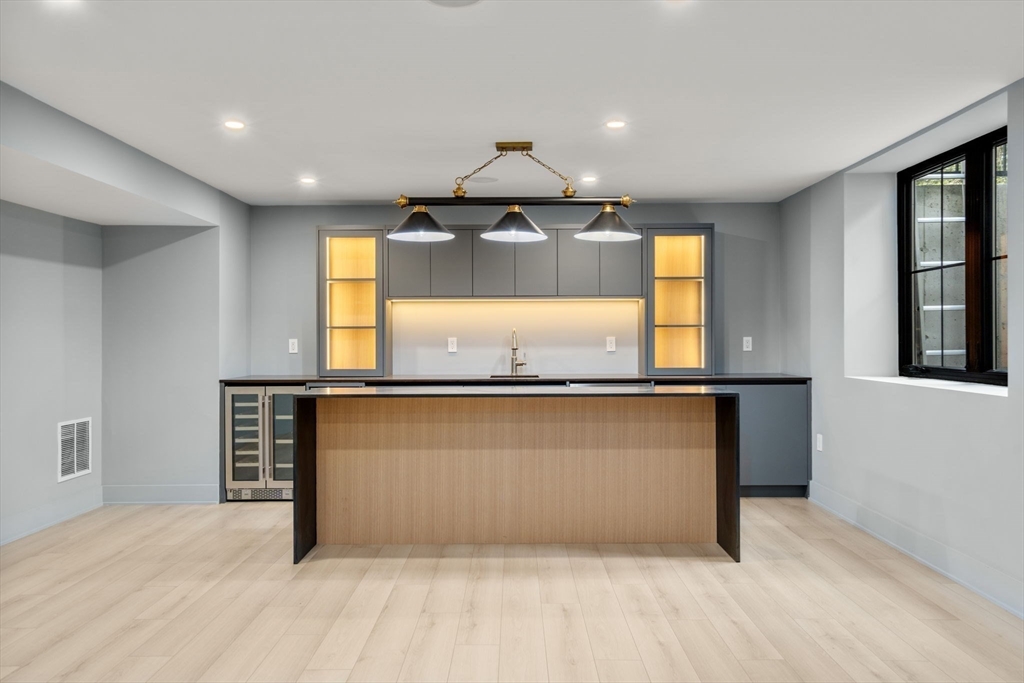 68 Locust Lane Needham, MA 02492 - Photo 29 of 39 a view of kitchen with granite countertop cabinets and wooden floor