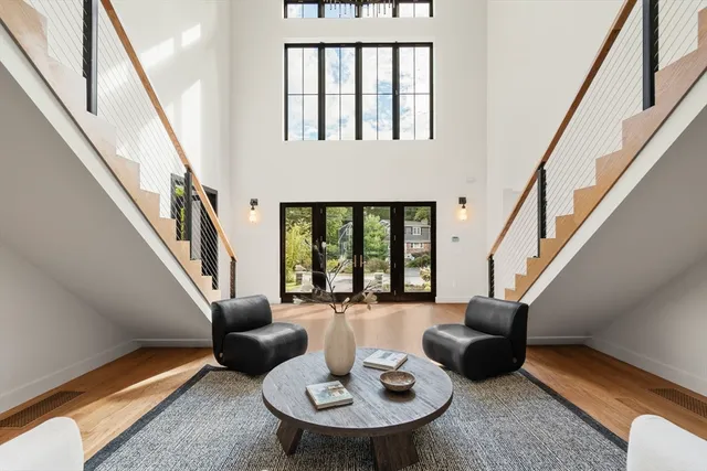 a living room with furniture and a floor to ceiling window