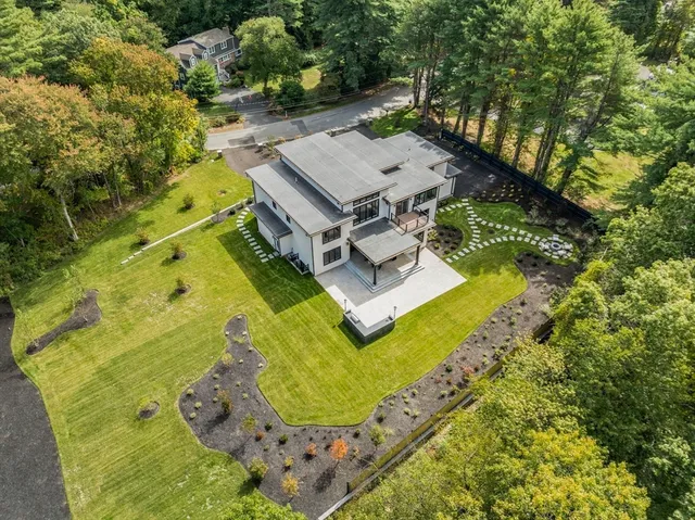 an aerial view of a house with pool outdoor seating yard and green space