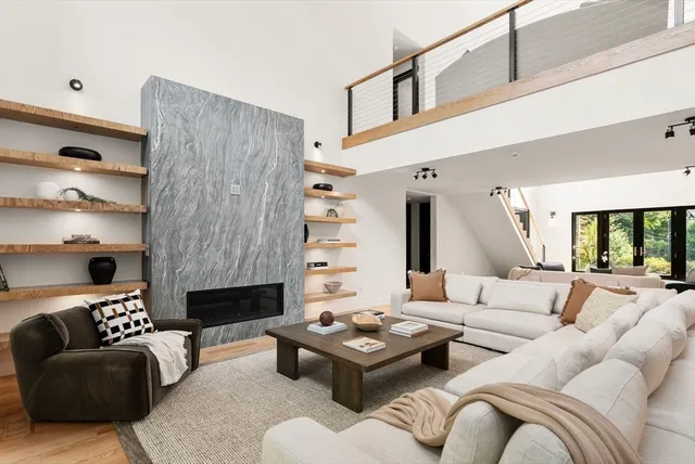 a living room with furniture and a fireplace