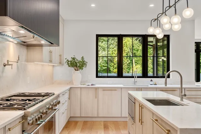 a kitchen with a sink and a stove top oven