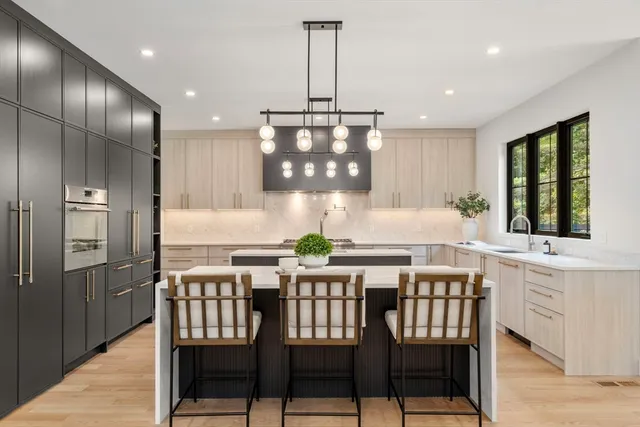 a kitchen with a dining table chairs and refrigerator